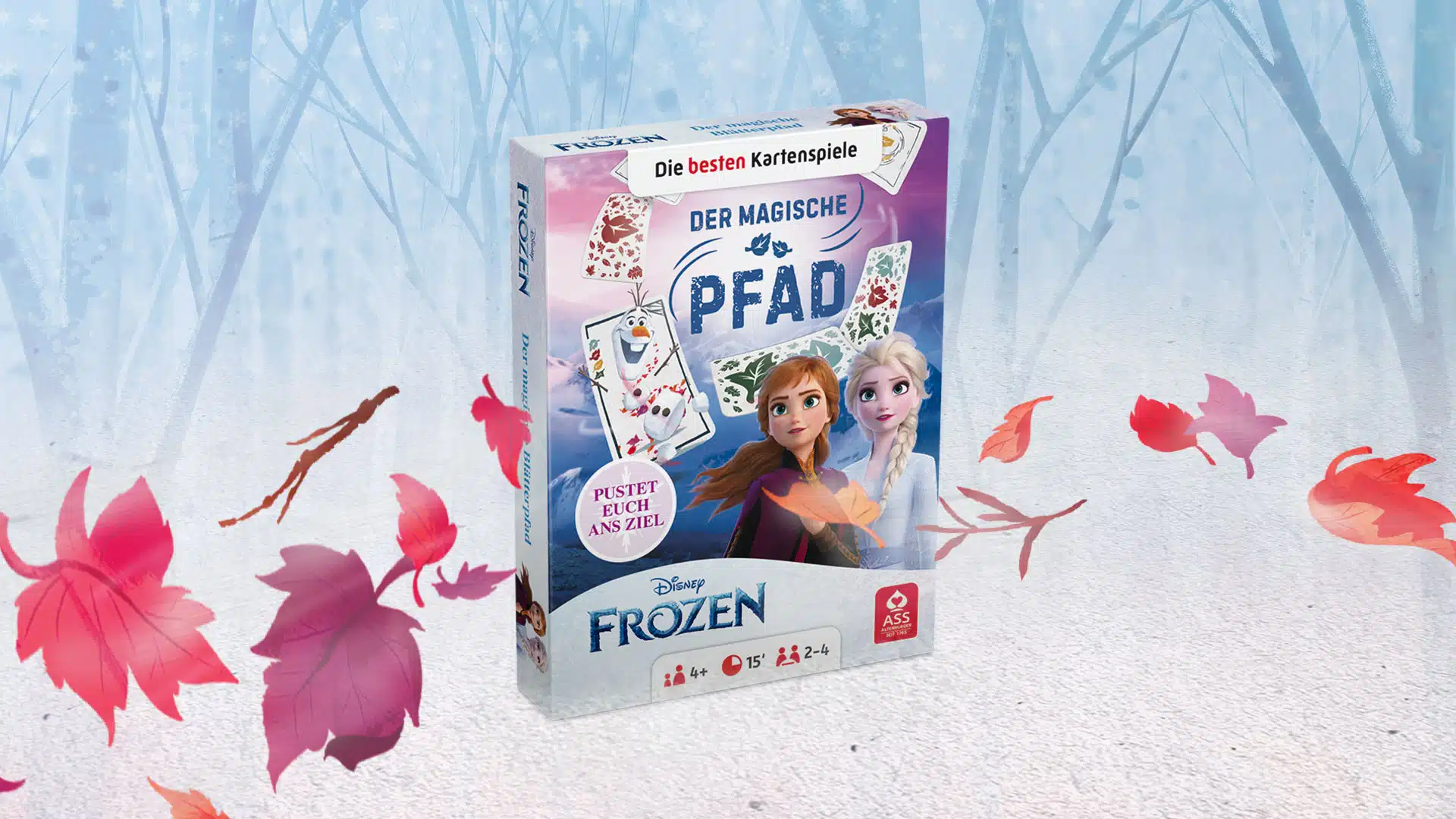 Das Disney Frozen der magische Pfad Spiel steht auf einem verschneitem Untergrund. Im Hintergrund ist ein verschneiter Wald zu erkennen, um das Spiel herum fliegen ein paar bunte Laubblätter im Wind.